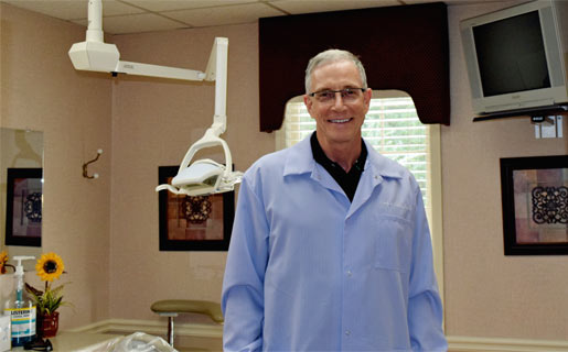 dentist, dr. craig fievet, in dental treatment room